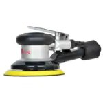 Silver and black self-vacuum pneumatic orbital sander (pneumatic grinder) with yellow hook-and-loop sanding pad and rear dust exhaust port