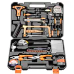 Open black and orange hardware hand tool set in a molded carry case, holding screwdrivers, hammer, pliers, hex keys, sockets, tape measure, and utility knife